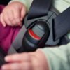 child in car seat showing buckle and harness